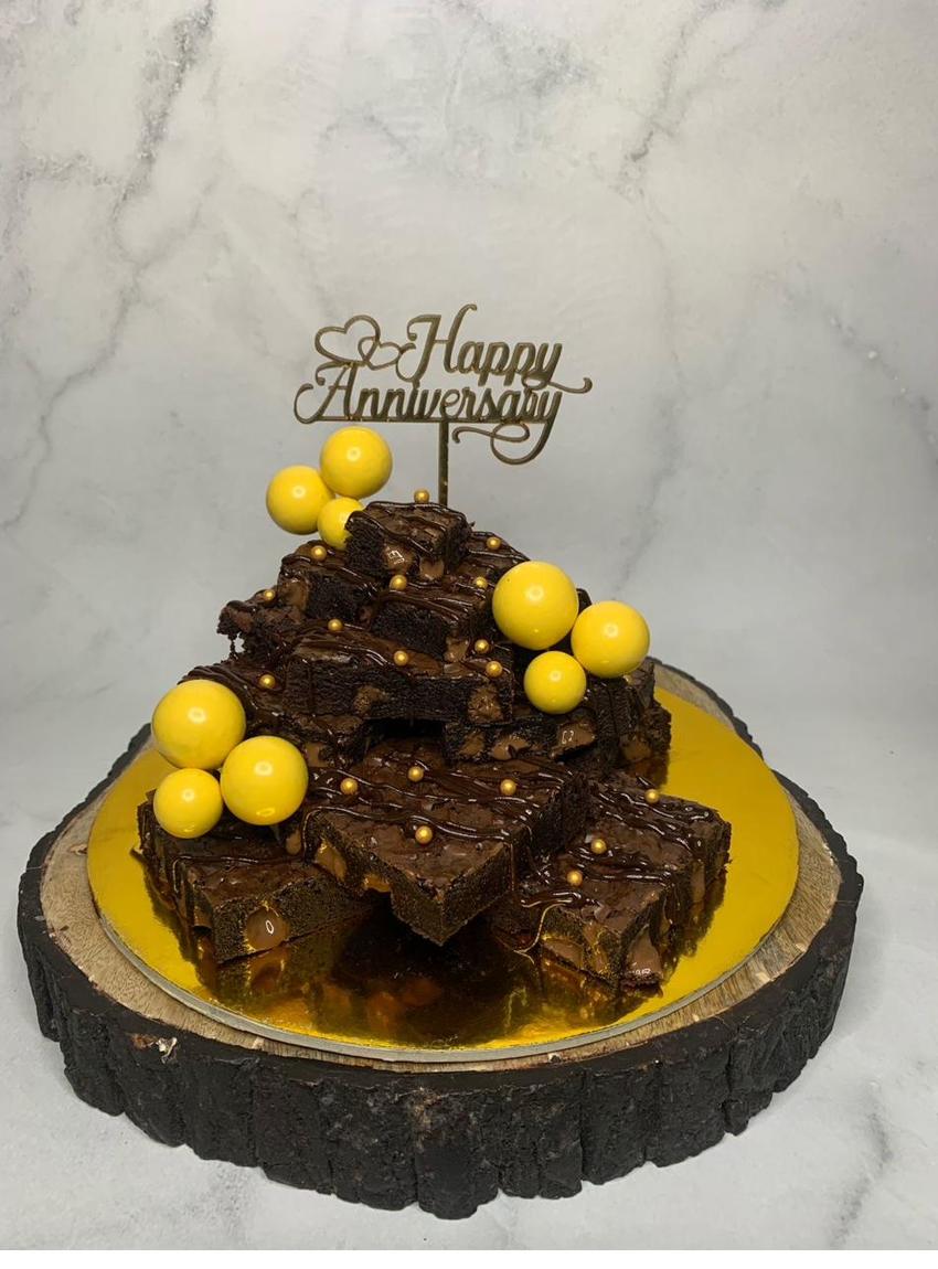 A celebration slab of chocolate brownies decorated with gold accents